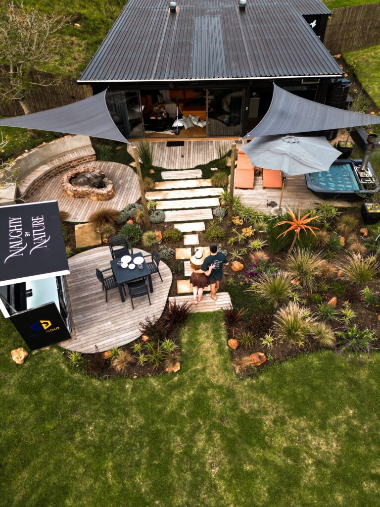 Aerial view of the Naughty by Nature deck, outdoor kitchen and table set for two