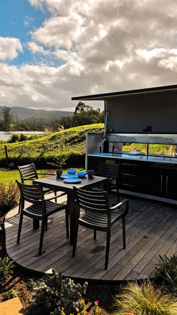 Outdoor kitchen and dining deck with mountain views at Naughty by Nature, Wilderness