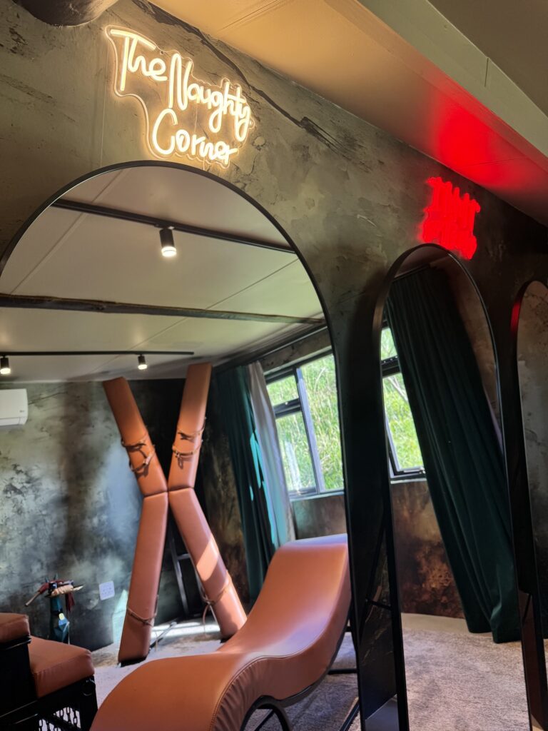 The private playroom at Naughty by Nature seen through an arched doorway, Wilderness